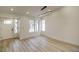 Bright living room featuring wood-look flooring, modern lighting, and a large window for plenty of natural light at 9741 Panorama Cliff Dr, Las Vegas, NV 89134