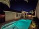Inviting backyard pool, perfect for evening swims with landscape lighting and covered patio at 9741 Panorama Cliff Dr, Las Vegas, NV 89134