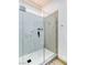 A modern walk-in shower with a glass enclosure, white tile, and modern fixtures and design at 9741 Panorama Cliff Dr, Las Vegas, NV 89134