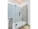 A modern walk-in shower with a glass enclosure, white tile, and modern fixtures and design at 9741 Panorama Cliff Dr, Las Vegas, NV 89134