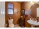 Stylish powder room with modern vanity, decorative mirror, attractive paint, and contemporary fixtures at 976 Baronet Dr, Las Vegas, NV 89138