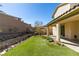 Spacious backyard with artificial turf, covered patio, and privacy wall at 981 Soaring Moon Dr, Henderson, NV 89015