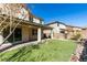 Outdoor view of the house with artificial grass and covered patio at 981 Soaring Moon Dr, Henderson, NV 89015