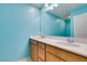 Bright bathroom with dual sinks, wood cabinets, and large mirror at 981 Soaring Moon Dr, Henderson, NV 89015