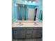 Bathroom featuring double sink vanity with gray cabinets, recessed lights, and ceramic tile flooring at 981 Soaring Moon Dr, Henderson, NV 89015