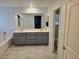 Bathroom with double sink vanity, shower with glass doors, soaking tub, and ceramic tile flooring at 981 Soaring Moon Dr, Henderson, NV 89015
