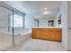 Bathroom features dual sinks, shower, tub, and tile floors at 981 Soaring Moon Dr, Henderson, NV 89015