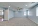 Carpeted bedroom with large windows and a ceiling fan at 981 Soaring Moon Dr, Henderson, NV 89015