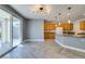 Bright kitchen features an island, wooden cabinets, and sliding glass door to backyard at 981 Soaring Moon Dr, Henderson, NV 89015