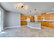 This kitchen has recessed lighting, wooden cabinets, and an island with granite countertop at 981 Soaring Moon Dr, Henderson, NV 89015