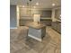 Spacious kitchen features gray cabinets, a granite island, and modern stainless steel appliances at 981 Soaring Moon Dr, Henderson, NV 89015