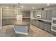 Spacious kitchen features gray cabinets, a granite island, and modern stainless steel appliances at 981 Soaring Moon Dr, Henderson, NV 89015