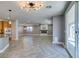 Open living area features wood-look flooring, modern lighting, and sliding glass door to the patio at 981 Soaring Moon Dr, Henderson, NV 89015