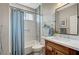 Well-lit bathroom featuring a tiled shower/tub, modern vanity, and stylish fixtures at 10397 Walking View Ct, Las Vegas, NV 89135