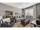 Cozy living room with hardwood floors, neutral paint, and lots of natural light at 10397 Walking View Ct, Las Vegas, NV 89135