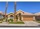 Beautiful single-story home with a tile roof, arched entry, desert landscaping, and a two-car garage at 105 Eagleview Ct, Henderson, NV 89074