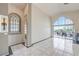 Bright living room featuring tile flooring, a vaulted ceiling, and access to an outdoor patio at 105 Eagleview Ct, Henderson, NV 89074