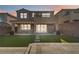 Inviting backyard with artificial turf, a covered patio, and elegant outdoor string lighting at 11548 Salt Creek Ave, Las Vegas, NV 89138