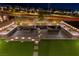 Aerial view of a backyard oasis with pavers, an outdoor kitchen and hot tub; ideal for evening relaxation at 11548 Salt Creek Ave, Las Vegas, NV 89138