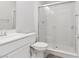 Bright bathroom with modern vanity and walk-in shower featuring glass doors and chrome fixtures at 11548 Salt Creek Ave, Las Vegas, NV 89138