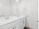Bright bathroom featuring dual sinks and white cabinetry at 11548 Salt Creek Ave, Las Vegas, NV 89138