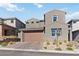 Modern two-story home features a paver driveway, drought tolerant landscaping, and an attached two-car garage at 11548 Salt Creek Ave, Las Vegas, NV 89138