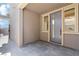 Inviting covered front porch with a modern door and side windows, creates a welcoming entry to the home at 11548 Salt Creek Ave, Las Vegas, NV 89138
