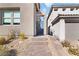 Exterior view of the front entrance featuring a stone path and low-maintenance landscaping for modern appeal at 11548 Salt Creek Ave, Las Vegas, NV 89138