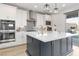 Gourmet kitchen featuring stainless appliances, custom backsplash, and center island with stone countertop at 11548 Salt Creek Ave, Las Vegas, NV 89138