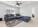 Cozy living room with plush sectional sofa, neutral decor, and ample space for relaxing at 11548 Salt Creek Ave, Las Vegas, NV 89138