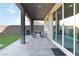 Covered patio featuring pavers, an outdoor table, and a sliding glass door leading inside at 11548 Salt Creek Ave, Las Vegas, NV 89138