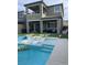 Beautiful backyard boasts a sparkling pool with lounge chairs, covered patio, and lush green space for outdoor enjoyment at 12451 Island Bells Ave, Las Vegas, NV 89138