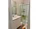 Bathroom with a modern vanity, framed mirror, and glass-enclosed shower stall at 12451 Island Bells Ave, Las Vegas, NV 89138