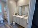 Bright bathroom features double sinks, a large mirror, and a shower-tub combo at 12451 Island Bells Ave, Las Vegas, NV 89138
