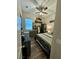 Bedroom with a bed and light wood flooring, ceiling fan, and a large window at 12451 Island Bells Ave, Las Vegas, NV 89138