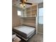 Bedroom featuring a built-in Murphy bed open with shelves above for storage in neutral tones at 12451 Island Bells Ave, Las Vegas, NV 89138