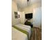 Cozy bedroom featuring modern decor, a mounted TV, and wood-look flooring at 12451 Island Bells Ave, Las Vegas, NV 89138