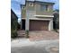 Charming two-story home features a well-manicured front yard, a two-car garage, and a welcoming entrance at 12451 Island Bells Ave, Las Vegas, NV 89138