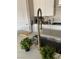 Close-up of a kitchen sink featuring a modern faucet, granite countertops, and ample storage space at 12451 Island Bells Ave, Las Vegas, NV 89138