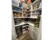 Well-organized pantry with ample shelving, storage containers, and a beverage refrigerator at 12451 Island Bells Ave, Las Vegas, NV 89138