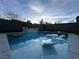 Backyard swimming pool and spa with built-in seating, fire feature and mature trees at 12451 Island Bells Ave, Las Vegas, NV 89138