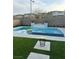 Beautiful backyard pool area featuring a spa, fire feature, and comfortable seating at 12451 Island Bells Ave, Las Vegas, NV 89138
