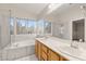 Bathroom featuring a soaking tub, a shower and a double sink vanity with a large mirror at 1708 Imperial Cup Dr, Las Vegas, NV 89117