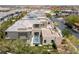 Birds-eye view of a contemporary home with a pool, landscaping, and rooftop solar panels at 18 Sugarberry Ln, Las Vegas, NV 89135