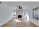 Bright living room with fireplace, fan, and wood-look flooring at 1800 N Jones Blvd, Las Vegas, NV 89108