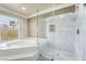 Bright bathroom features a soaking tub, glass enclosed shower, and a large window with natural light at 1804 Michael Ct, Henderson, NV 89014