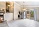 The dining area features tile flooring, sliding glass doors to the backyard, and a view of the staircase at 1804 Michael Ct, Henderson, NV 89014