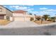 A single-Gathering home exhibits a two-car garage, a low-maintenance yard, and a traditional Southwest design at 1804 Michael Ct, Henderson, NV 89014