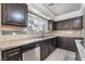 Kitchen featuring stainless steel dishwasher and wood cabinetry at 1804 Michael Ct, Henderson, NV 89014