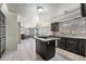 Modern kitchen has granite countertops, stainless appliances, and dark cabinetry with a kitchen island at 1804 Michael Ct, Henderson, NV 89014